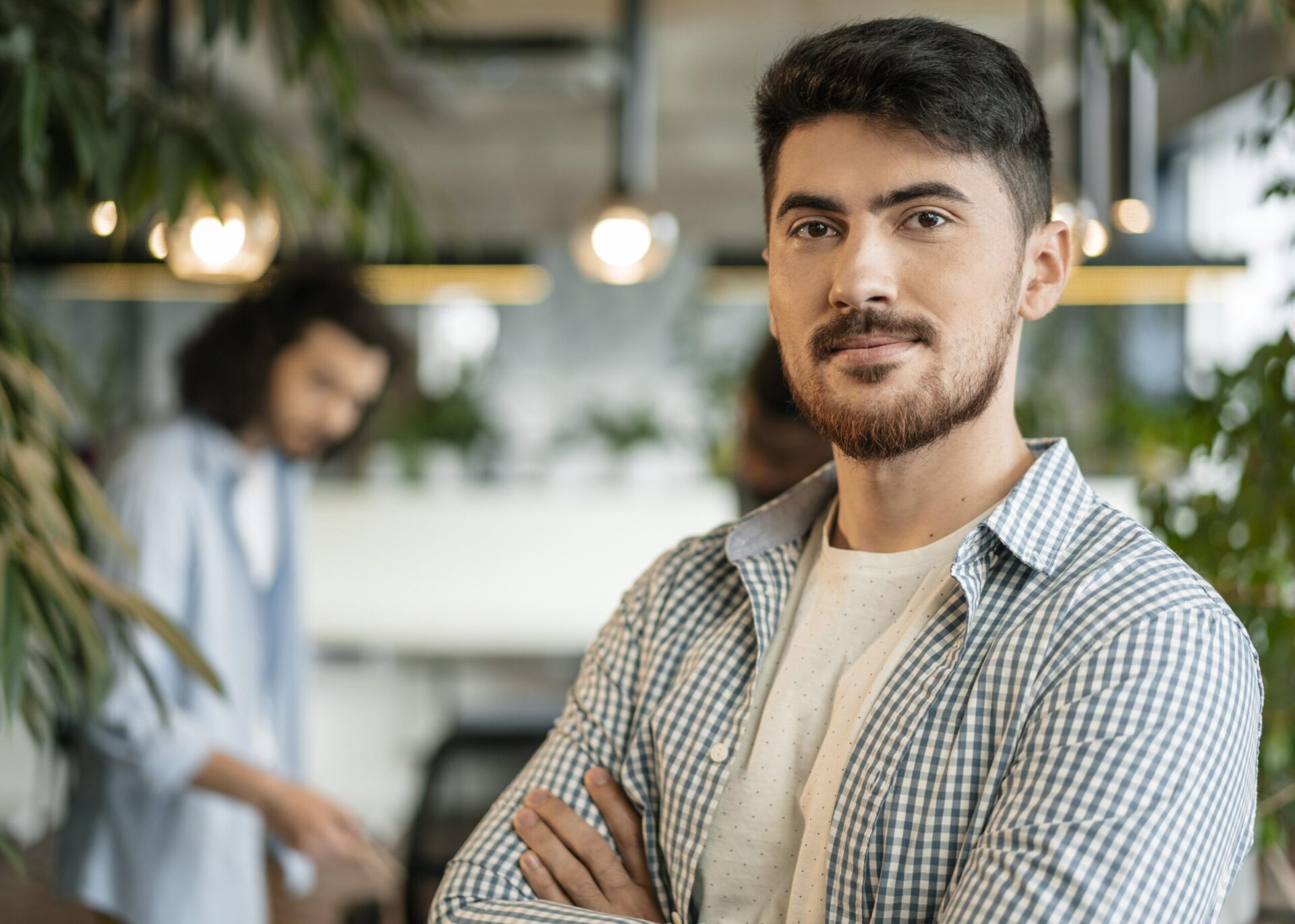 Man in office environment with another in background