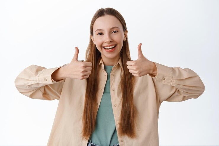 Woman smiling and giving thumbs up